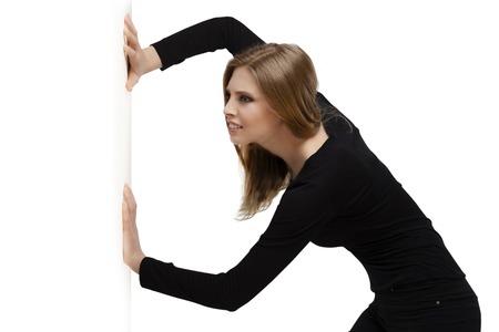 beautiful girl pushes with force, job conceptの写真素材