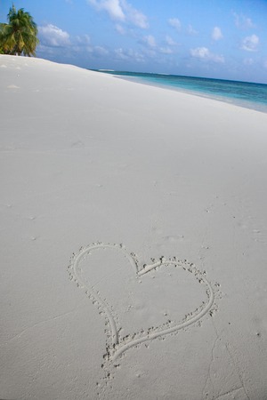 beautiful beach of maldives with heart in the sandの写真素材