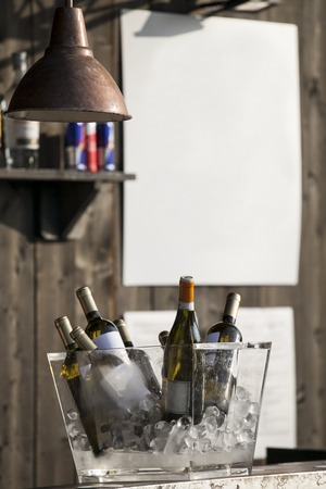 bar counter with bottles cool in the bucket with iceの写真素材