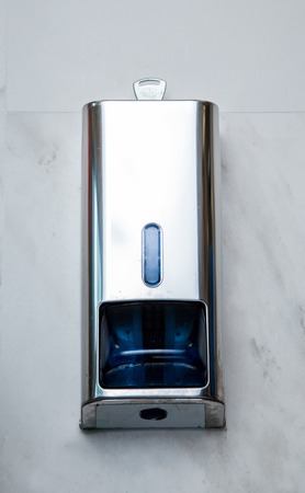 metal dispensers for toilet paper empty, on a wallの写真素材