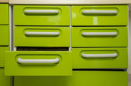 metal drawers in row, of which one is openの写真素材