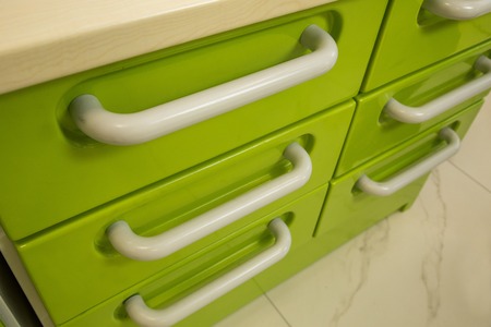 metal drawers in row, of which one is openの写真素材