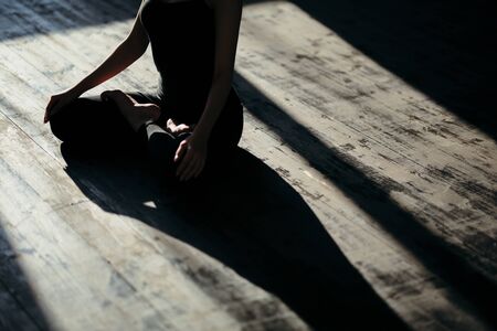 asian young woman sitting in Lotos pose. Businesswoman practicing meditation in yoga hall after finish working. Time for Yoga and relaxationの写真素材