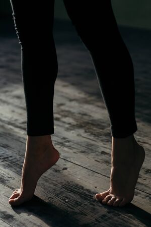 Female feet walking on warm heated floor close up view, barefoot girl legs going on hardwood living...