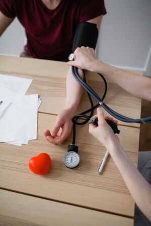 The patient doctor measures the pressure of his patientの写真素材
