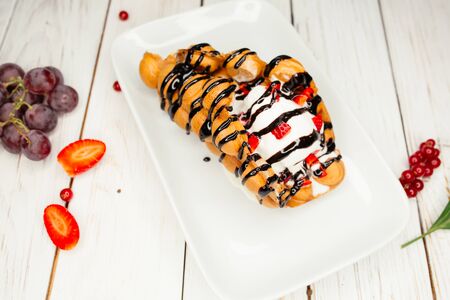 Appetizing sweet dessert on a white plate. A restaurant dish on the table decorated with...