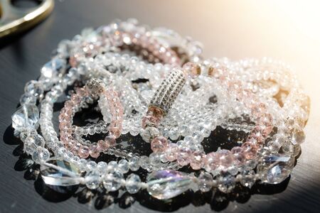 Glass beads, bracelets, necklaces and other jewelry shine and shimmer in the sunの写真素材