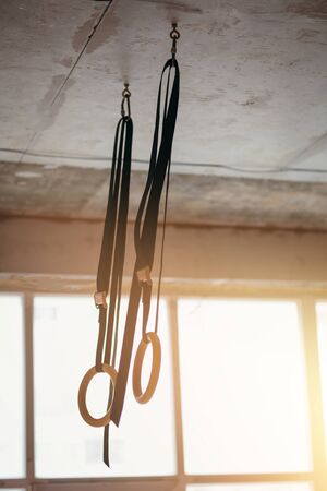 Gymnastics rings hanging under the ceiling of the gym for professional gymnasticsの写真素材