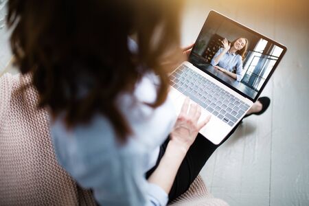 Close up laptop screen with businesswoman talking with her colleague in video calling on laptop in...