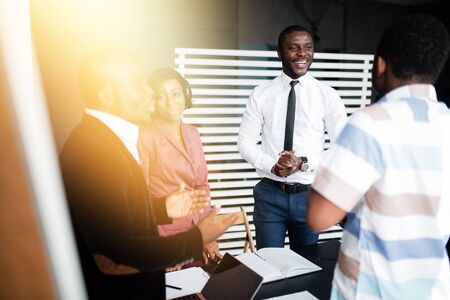 A large business company holds a morning meeting with a discussion of a new contract that the firm has entered into.の写真素材