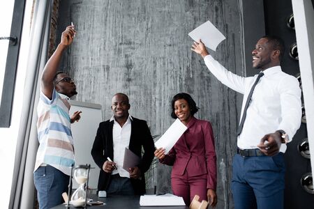 African-Americans in the company scatter joyfully documents for concluding a major contract in the office.の写真素材