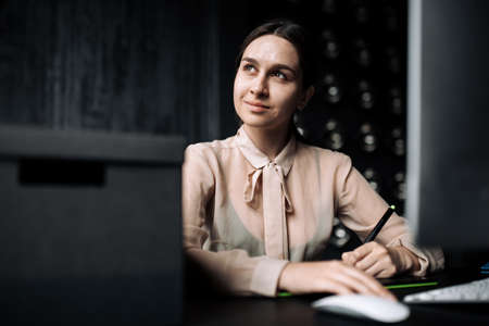Portrait photo girl designer comes up with a new concept for the project. Freelancer works at the...