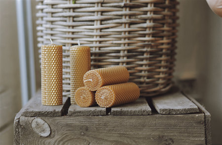 Wicker basket with candles on a wooden background. Selective focus.の写真素材