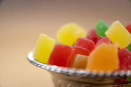 Many colorful sweet turkish delight (lokum) in a silver traditional bowl on brown background for holiday treats.の写真素材