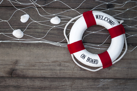 Maritime decoration with shells, starfish, sailing ship, fishing net on blue drift woodの写真素材