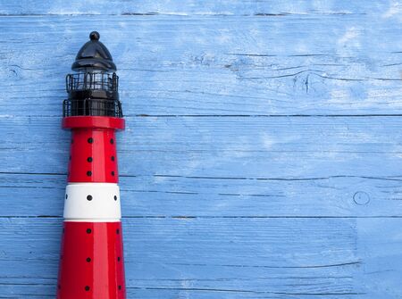 Maritime decoration with lighthouse on blue drift woodの写真素材