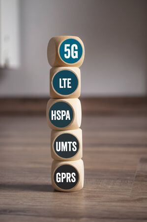 Cubes and dice with internet broadband standard 5G on wooden background