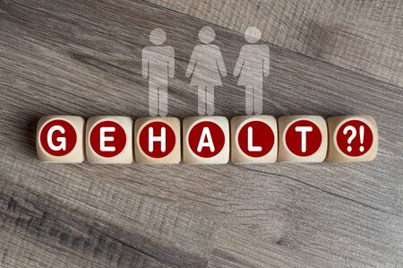 Cubes and dice with the german word for salary - Gehalt on wooden backgroundの写真素材