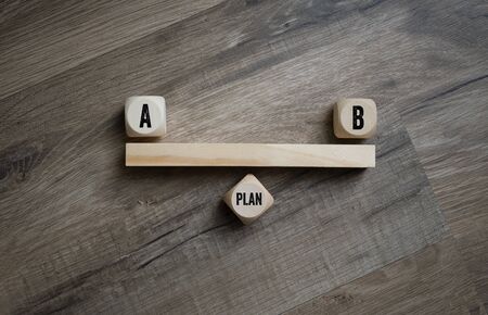 Cubes dice with plan a and plan b on wooden background