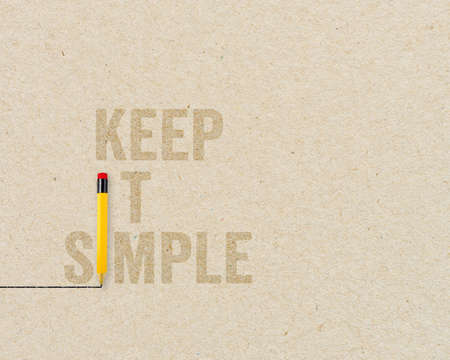 KISS Concept - Keep it simple and stupid with yellow pencils on brown paper and chalkboard...