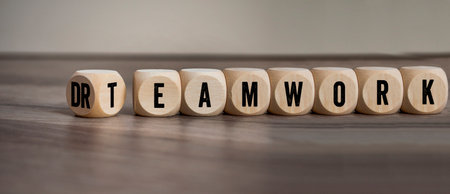 Cubes, dice or blocks with dreamwork and teamwork on wooden backgroundの写真素材