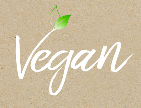 Brown recycled paper background with white colored lettering veganの写真素材