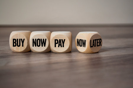 Cubes, dice or blocks with business message buy now pay later on wooden backgroundの写真素材