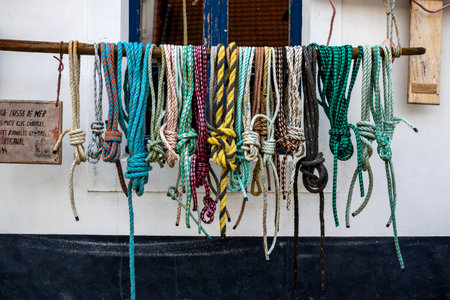 Different ropes hanging in front of a building in Aurdesselles Fanceの写真素材