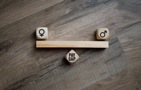 Cubes, dice or blocks with gender pay gap on wooden background