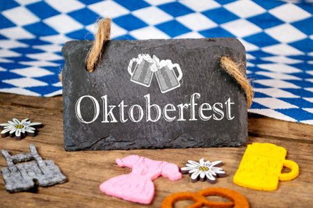 Chalkboard with bavarian decoration and with the German word Oktoberfest - Beer festival on wooden backgroundの写真素材