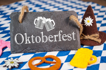 Chalkboard with bavarian decoration and with the German word Oktoberfest - Beer festival on wooden backgroundの写真素材