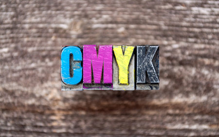 Metal Type or lead type and Cubes with CMYK on wooden backgroundの写真素材