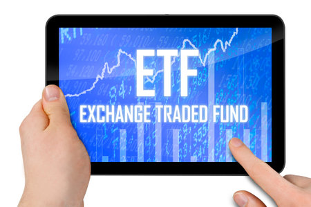Tablet with touchscreen and acronym etf - exchange traded fund isolated on white backgroundの写真素材