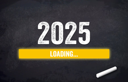 Black chalkboard with yellow loading bar and message Loading 2025の写真素材