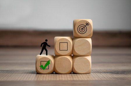 Cubes, dice or blocks with ladder and steps to success on wooden backgroundの写真素材
