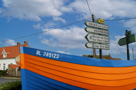 Landscapes with bleu cloudy sky from Audresselles, Ambleteuse and Wimereux in France with colorful boat with road signsの写真素材