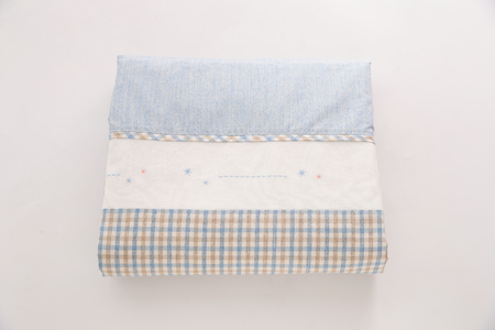 Folded grey cotton napkin isolated on white background top view