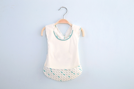 white cardigan kids shirt back view in clothes hanger, isolated on white background.の写真素材