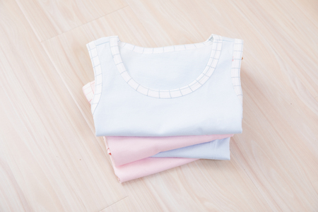 Baby clothes and accessories on wooden backgroundの写真素材