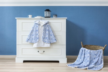 Baby clothes hanging on ropeの写真素材