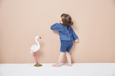 A lively and cheerful little girl, jumping and having fun.の写真素材
