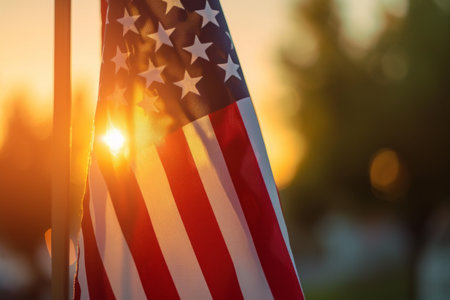 An American flag stands tall against the backdrop of the sun, creating a striking patriotic image.の素材