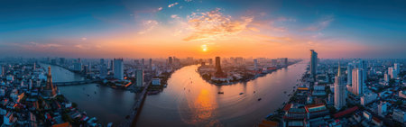 A city skyline with a river running through it and the sun setting in the background. The city is bustling with activity and the river is calm and peacefulの素材