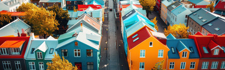 A row of colorful houses with a street in between. The houses are of different colors and sizesの素材