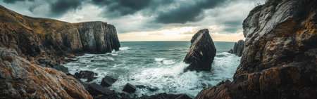 Witness the stunning cliffs at Falaise, where dramatic rock formations rise above the turbulent sea, waves crashing against the shoreline, all under a moody sky.の素材