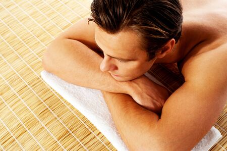 Man relaxing in a spa resort on mat  Relaxing with closed eyesの写真素材