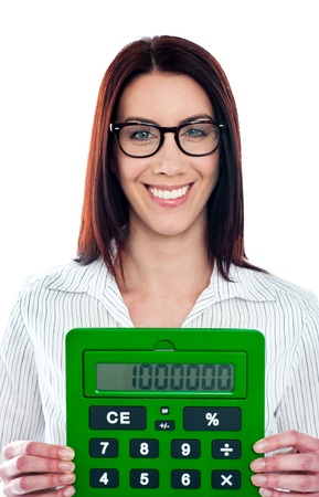Smiling corporate lady showing green calculator to cameraの写真素材