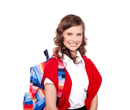 Smiling teenager student with colorful bag on her shouldersの写真素材