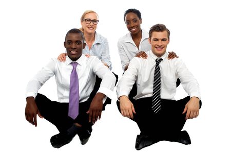 Business teams of two each. Healthy competition. Executives sitting on floorの写真素材