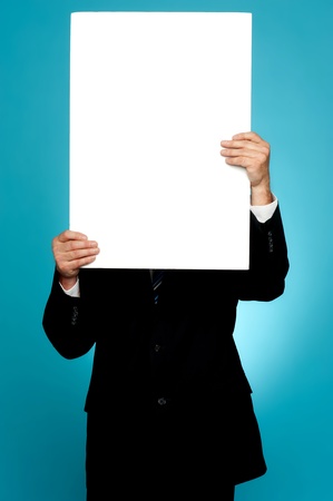 Manager hiding his face behind white banner ad isolated on gradient backgroundの写真素材